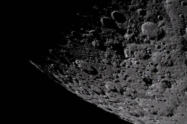 Cratered limb of the Moon photographed against black space