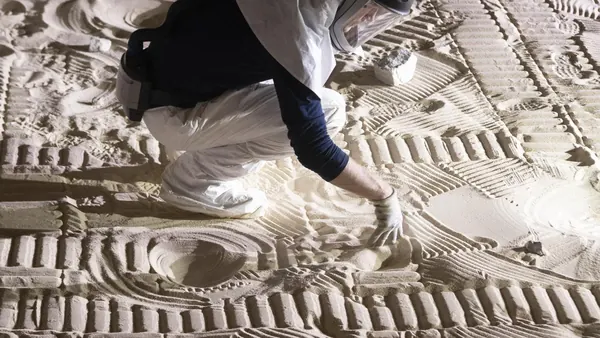 An engineer maps rock positions in a simulated lunar surface during VIPER rover mobility testing